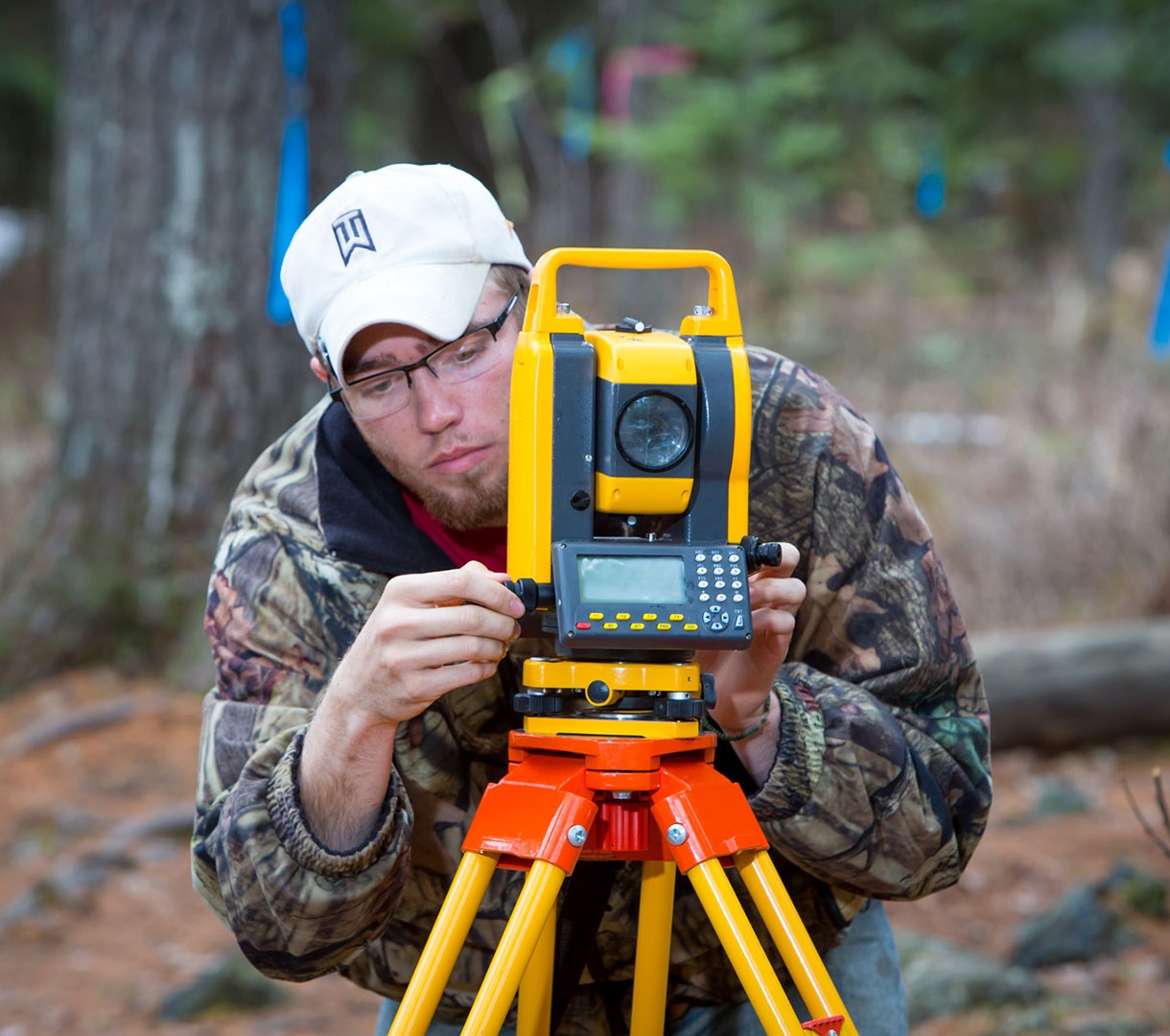 Student using land surveying equipment
